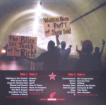 Man Lifting Banner: The Revolution Continues 2x12"